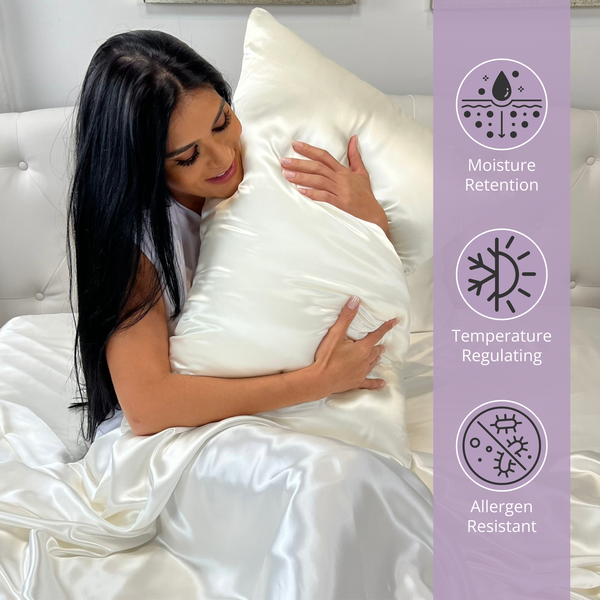 Woman sitting on bed, holding a ivory silk pillow and enjoying the comfort of silk sheets