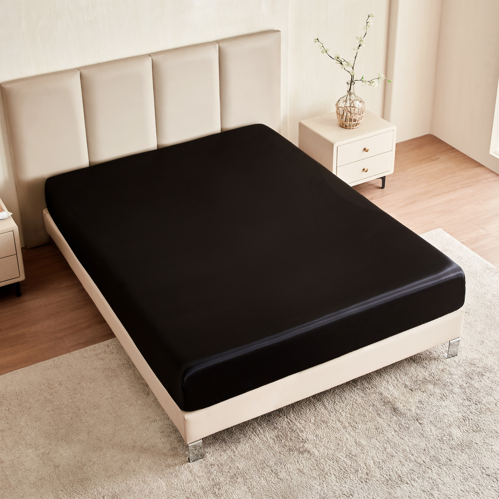 Black fitted sheet on a bed in a bedroom setting