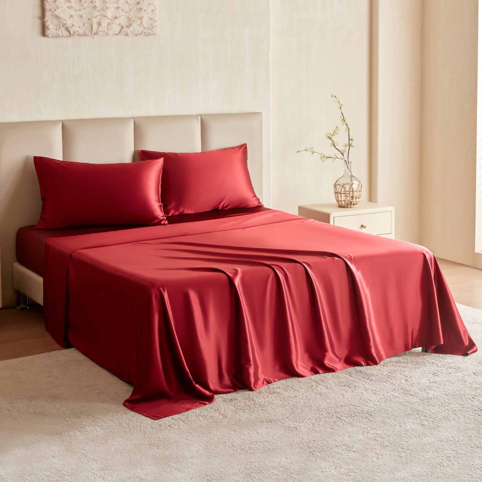 Luxurious cabernet red Mulberry Park Silks sheet set made from 100% pure Grade 6A Mulberry silk, displayed on a neatly styled bed with matching silk pillowcases.