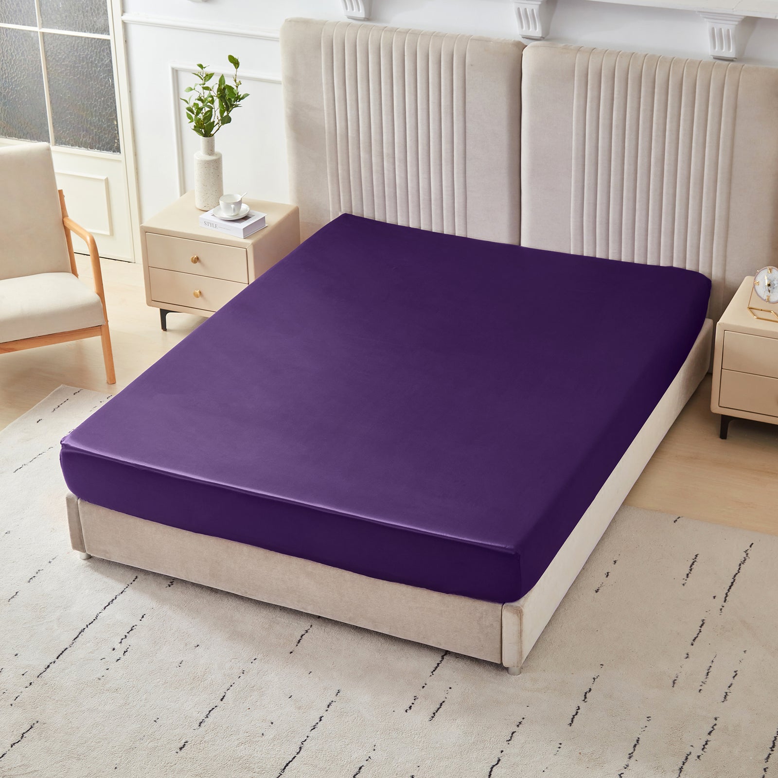 22 momme silk fitted sheet in Plum on bed with upholstered headboard in a cozy bedroom setting