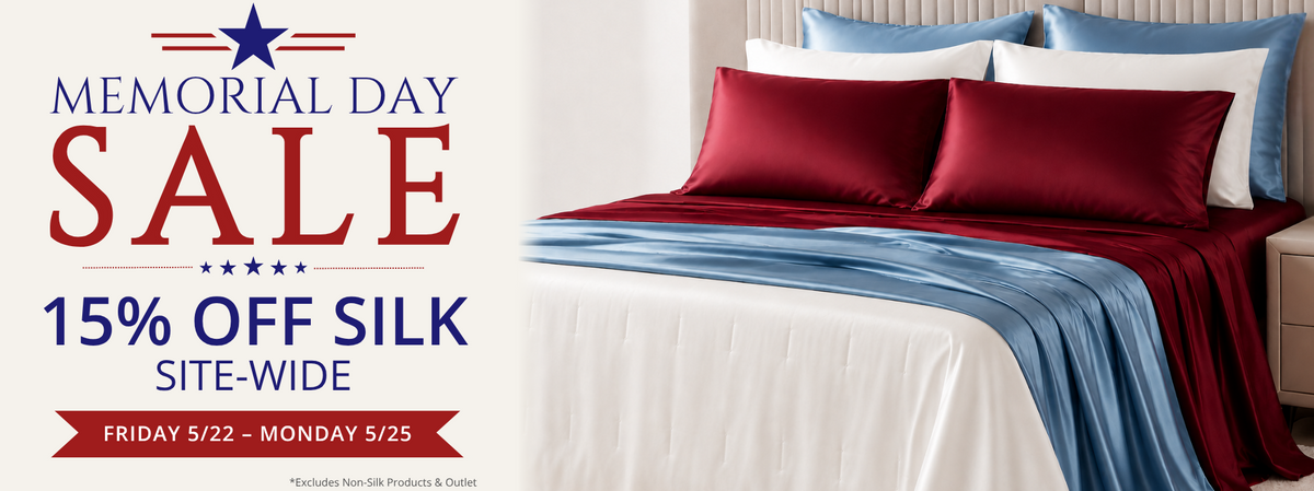 Bed with red and blue bedding and Memorial Day sale text on a white background