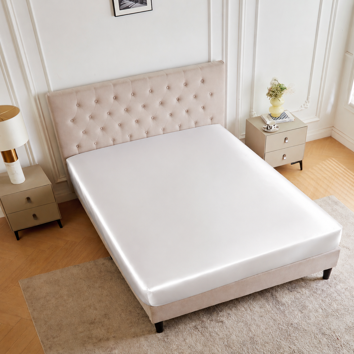Beige upholstered bed with a white 30 Momme Silk Fitted Sheet, flanked by nightstands in a bright, minimal bedroom.