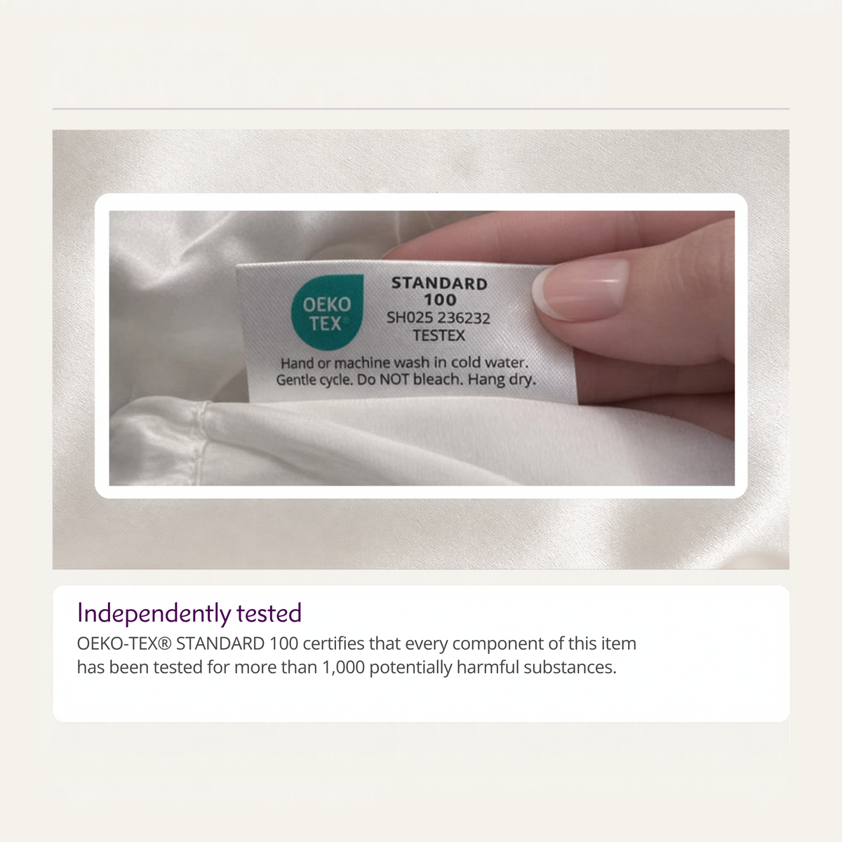 A hand holds a fabric tag labeled OEKO-TEX STANDARD 100 on a mulberry silk pillowcase, certifying it as safe.