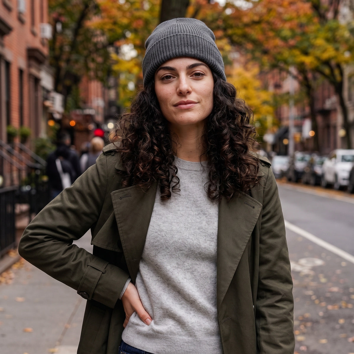 model with curly hair on city street wearing silk lined beanie in grey