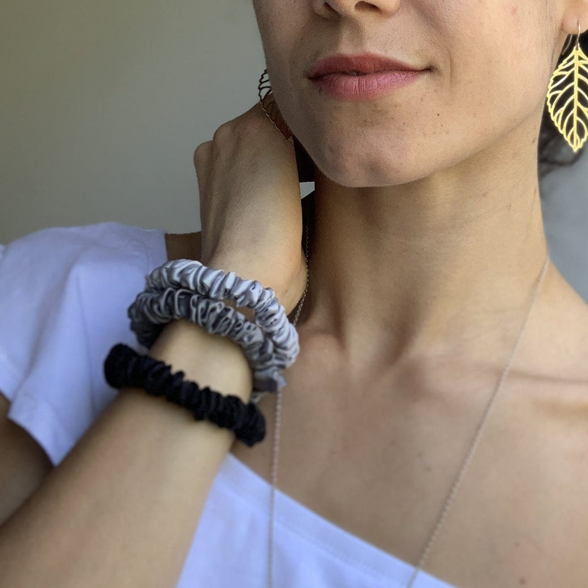 Mulberry Park Silks Silk Scrunchies - Midnight Black, Shimmery Silver, and Gunmetal Grey on Wrist Front